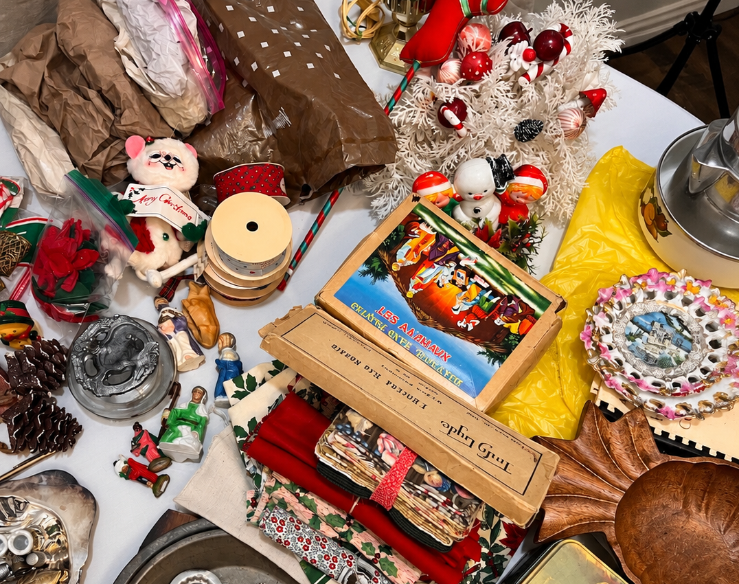 Photo of random items on a table someone is going through to prep an estate sale
