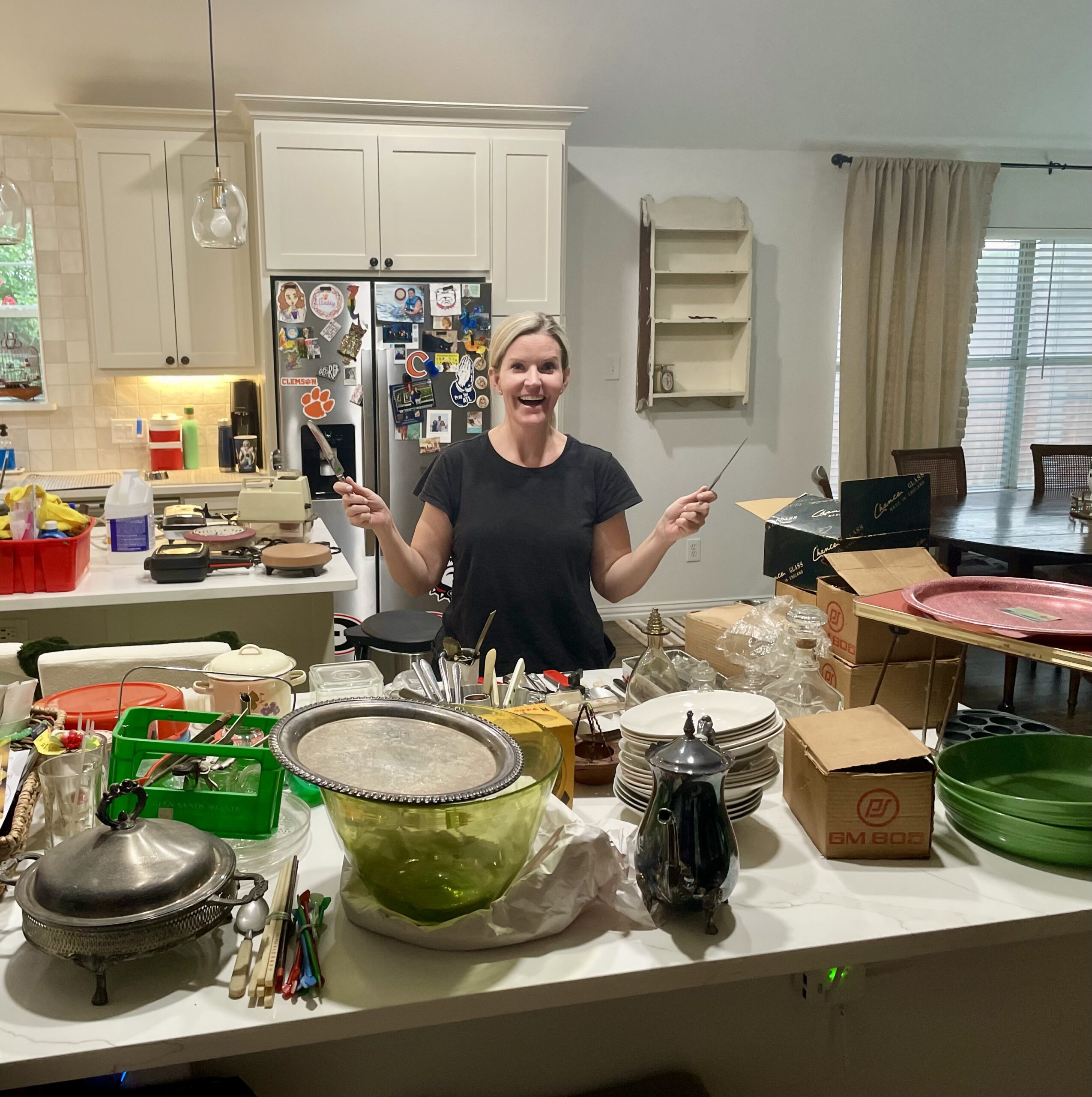 Heather Parker Vestal unpacking vintage antiques and collectibles from two online estate auction crates in her kitchen after pickup in Plano, Texas.