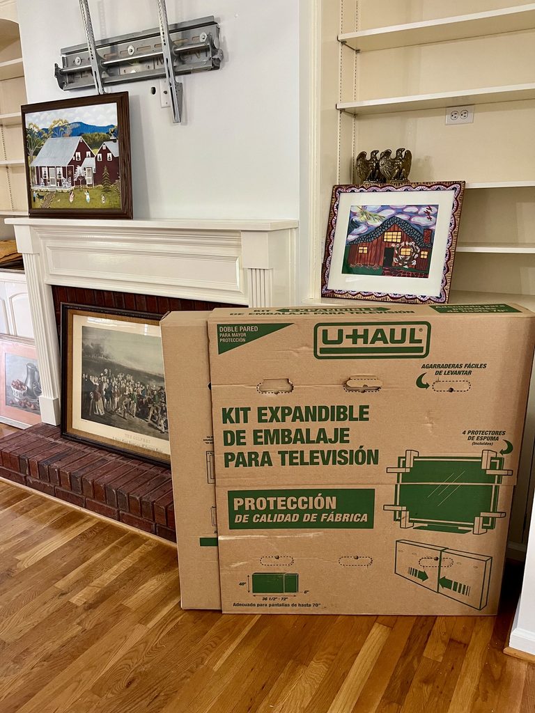 Framed artwork and packed household belongings during a family downsizing project