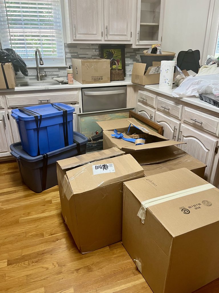 Packed boxes and storage totes filling a kitchen during a household move