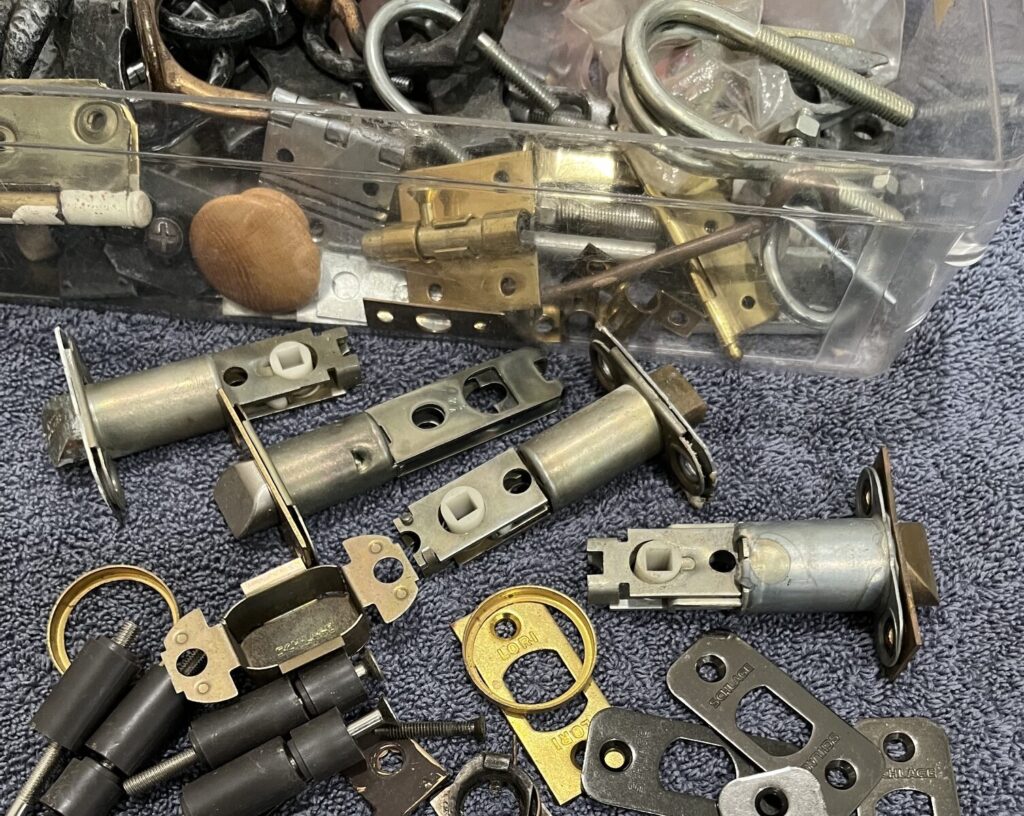 Assorted locks, hinges and household hardware that can sell at an estate sale