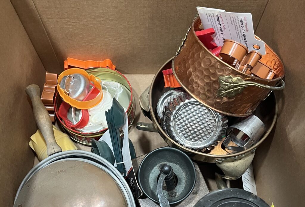 Box of everyday kitchenware and baking supplies for an estate sale