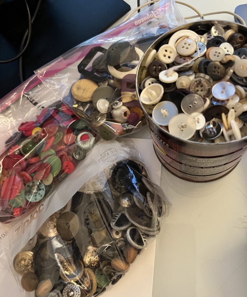 Collection of vintage buttons being sorted and evaluated during estate sale preparation